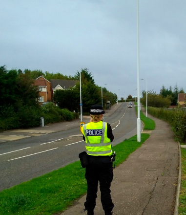Police lady - with speed camera in hand