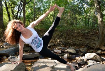 Lady enjoying the sunshine in the woods doing some exercise and Yoga