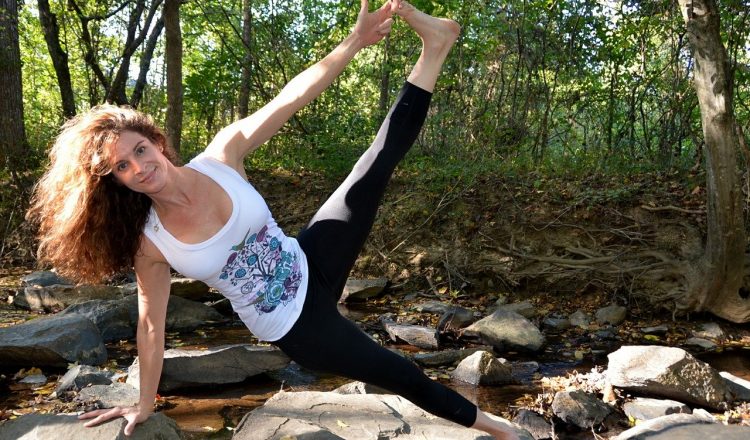 Lady enjoying the sunshine in the woods doing some exercise and Yoga